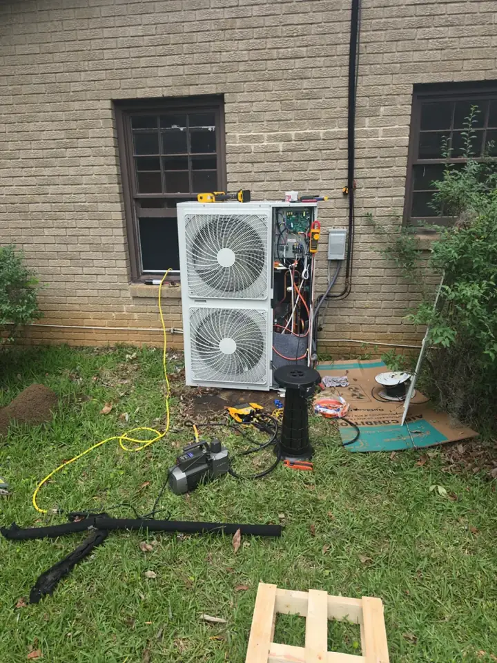 Price Heating And Cooling installing a new outdoor HVAC unit, with gauges and vacuum pump connected